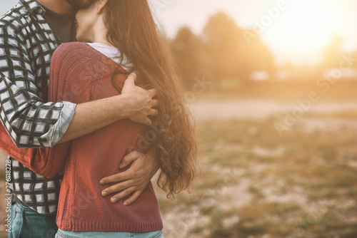 Canvas-taulu Young loving couple hugging outdoors