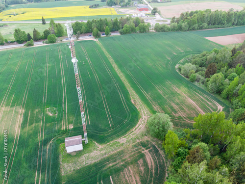 Aerial shot of mobile tower in green fields