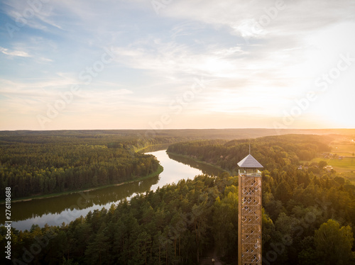 Aerial shot of wooden observation tower near the river loop