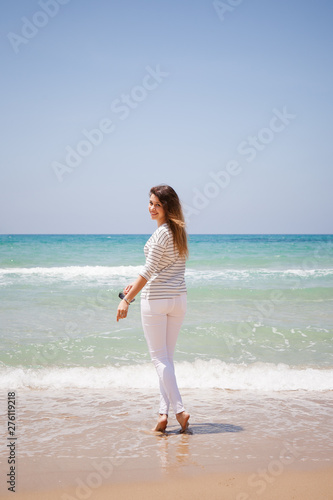 european girl having fun on the sea beach