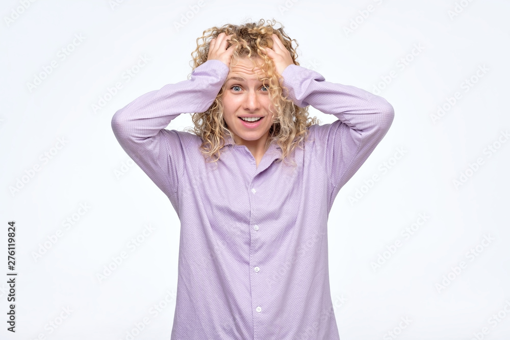 Excited sleepy young lady dressed in pajamas standing isolated over white background. Excited sleepy young lady dressed in pajamas standing isolated over white background.
