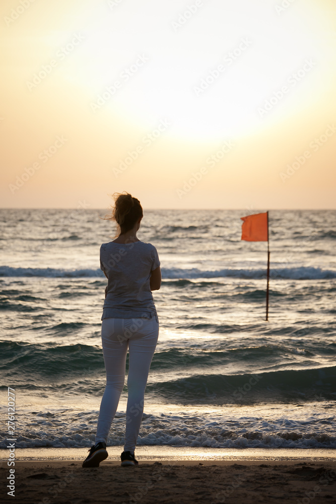 beautiful  girl at sunset on the sea