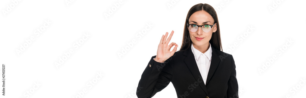 smiling businesswoman in black suit showing ok sign isolated on white, panoramic shot smiling businesswoman in black suit showing ok sign isolated on white, panoramic shot