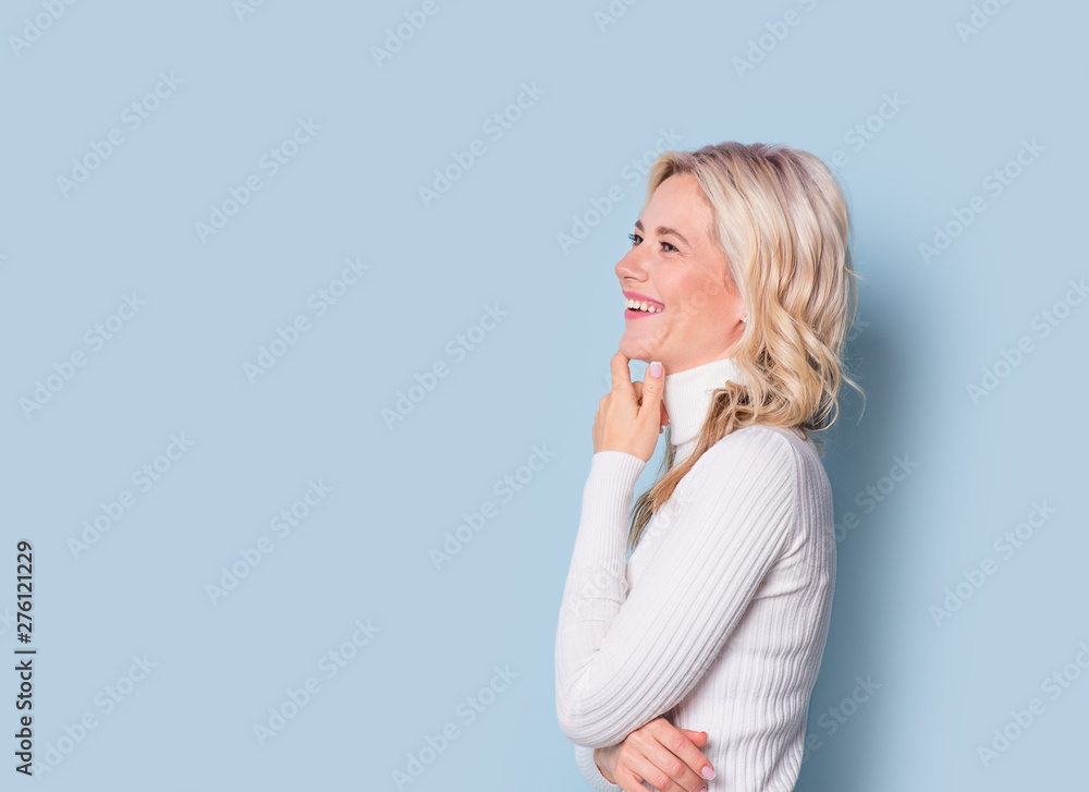 Blonde woman adult attractive beautiful portrait, cauasian and scandinavian girl on blue background Blonde woman adult attractive beautiful portrait, cauasian and scandinavian girl on blue background