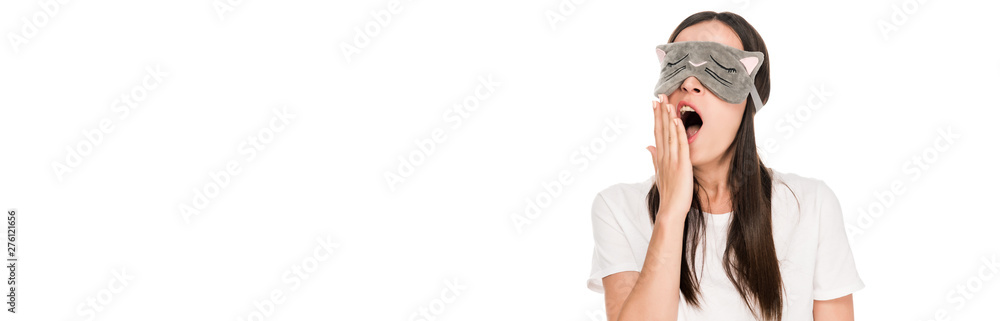 brunette young woman in cat sleeping eye mask yawning isolated on white, panoramic shot brunette young woman in cat sleeping eye mask yawning isolated on white, panoramic shot