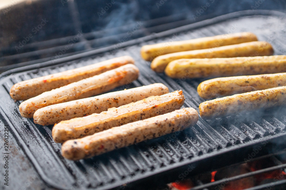 Cooking sausages on the barbecue grill. Grilled sausages Cooking sausages on the barbecue grill. Grilled sausages