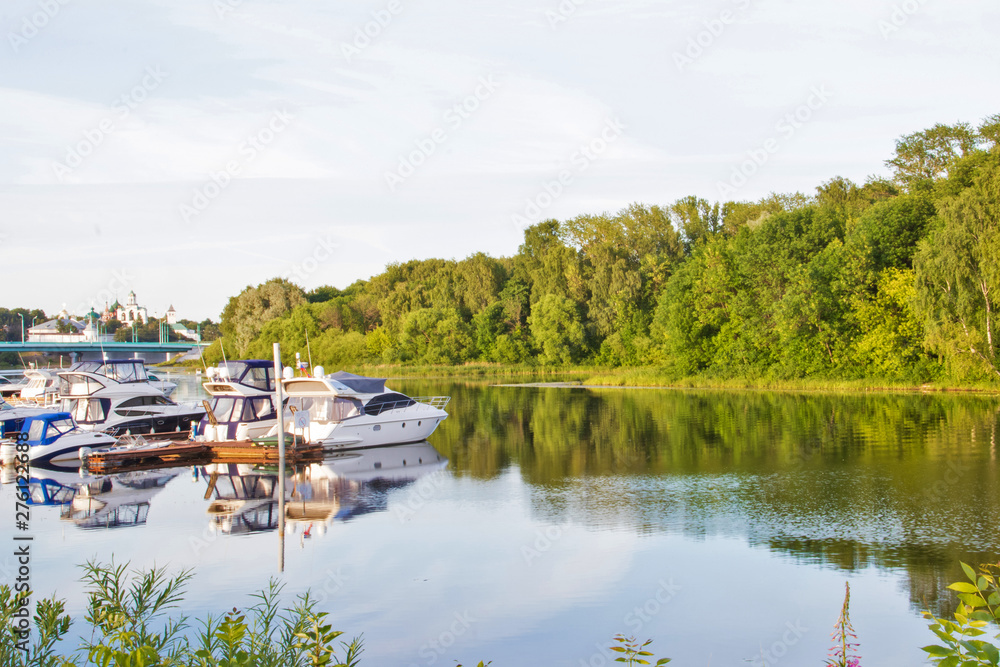 Yaroslavl. View of the Parking boats on the Kotorosl river and the Spaso-Preobrazhensky monastery. Summer evening before sunset Yaroslavl. View of the Parking boats on the Kotorosl river and the Spaso-Preobrazhensky monastery. Summer evening before sunset