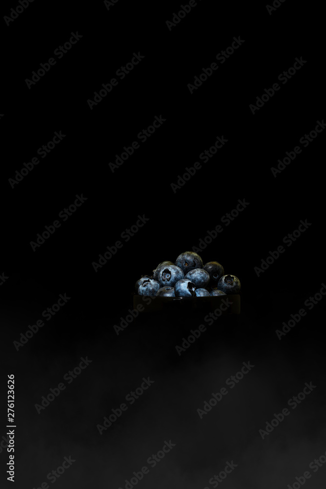 Blueberry in black bowl with smoke Blueberry in black bowl with smoke