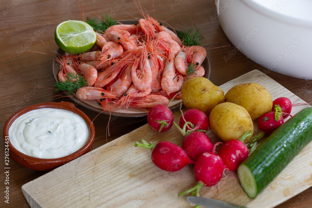 Сucumber, radish, cooked potato, white sauce and shrimps with lime as ingredients for salad Сucumber, radish, cooked potato, white sauce and shrimps with lime as ingredients for salad