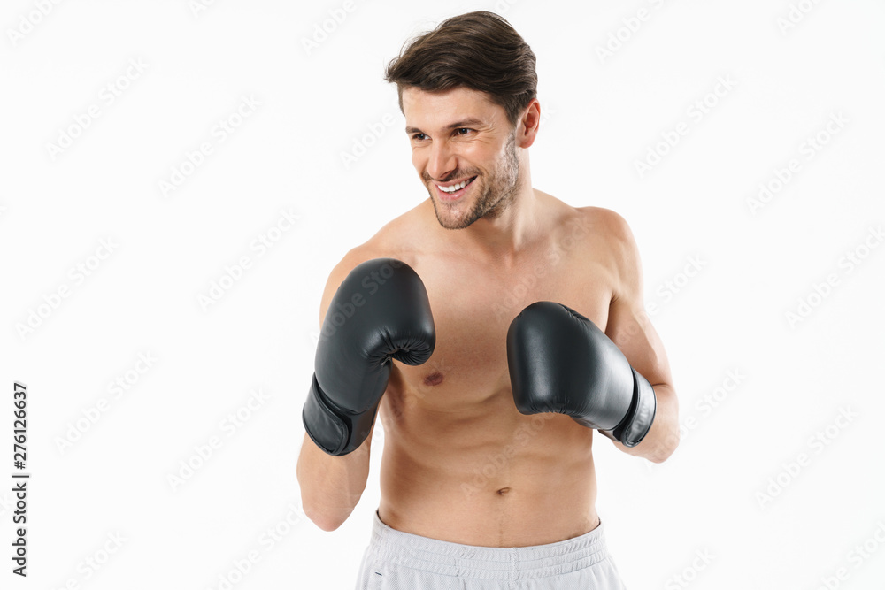 Handsome young fit shirtless sportsman standing Handsome young fit shirtless sportsman standing