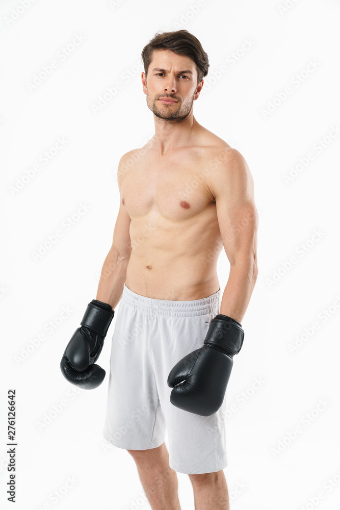 Handsome young fit shirtless sportsman standing Handsome young fit shirtless sportsman standing