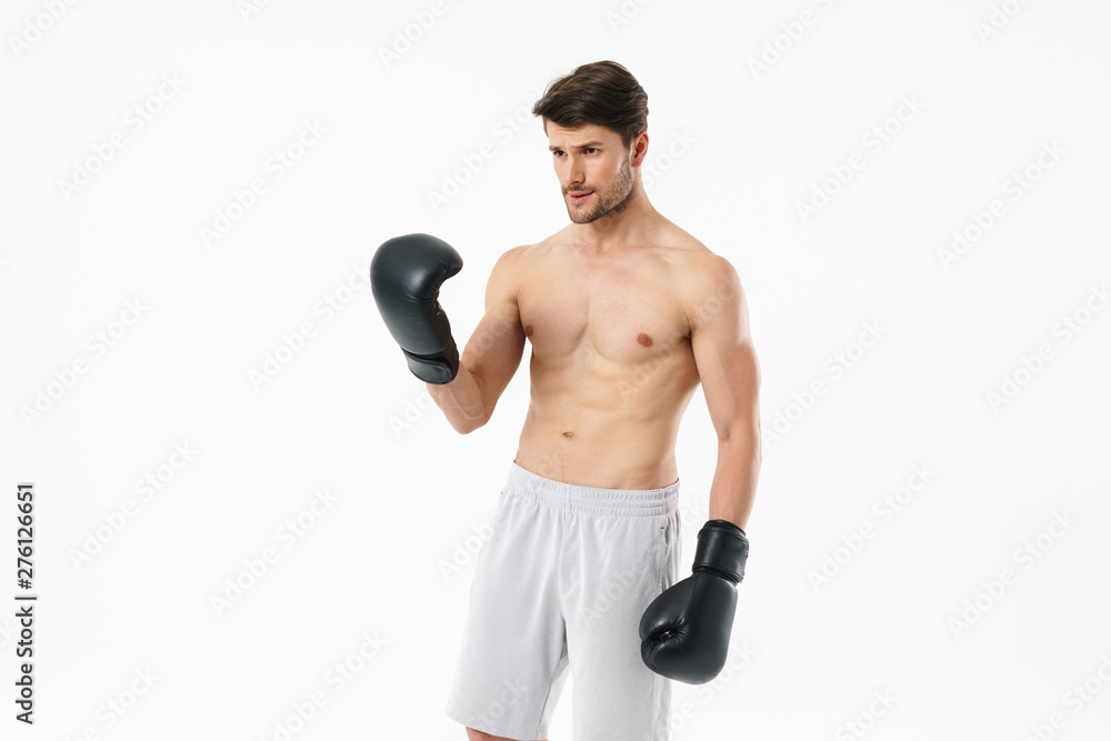 Handsome young fit shirtless sportsman standing
