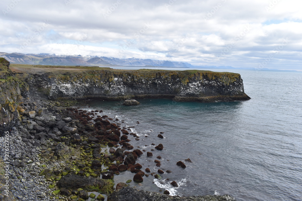Hiking trail from Anarstapi to Hellnar with the raw ocean und big rocks and mountains in the west of Iceland at Snaefellsnes Peninsula Hiking trail from Anarstapi to Hellnar with the raw ocean und big rocks and mountains in the west of Iceland at Snaefellsnes Peninsula
