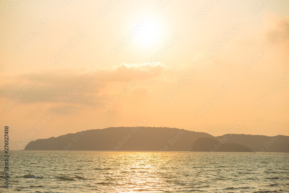 Beautiful landscape of sunset with pastel sky over calm sea and hills