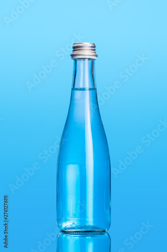 Glass water bottles on a light blue background