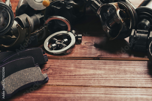 Various car parts on dark woooden background. toned photo