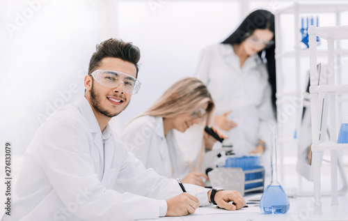 close up.young scientist sitting at his Desk in the laboratory