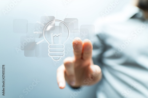  holding illuminated light bulb, idea, innovation and inspiration concept.