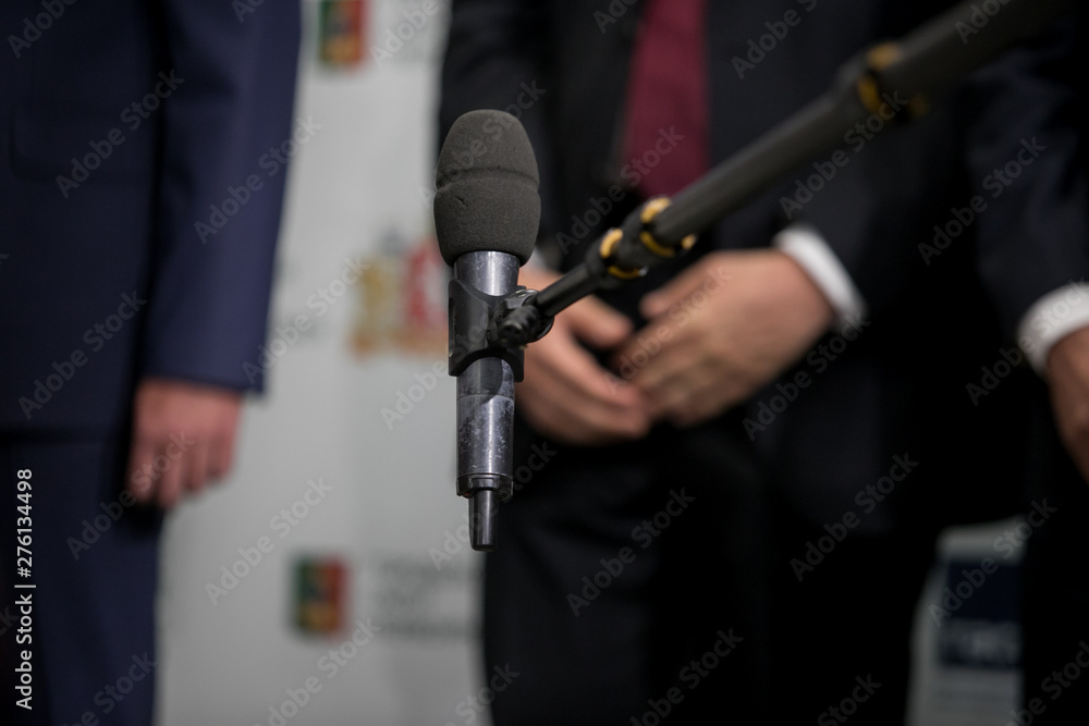 Fototapeta premium Media interview - group of journalists surrounding VIP