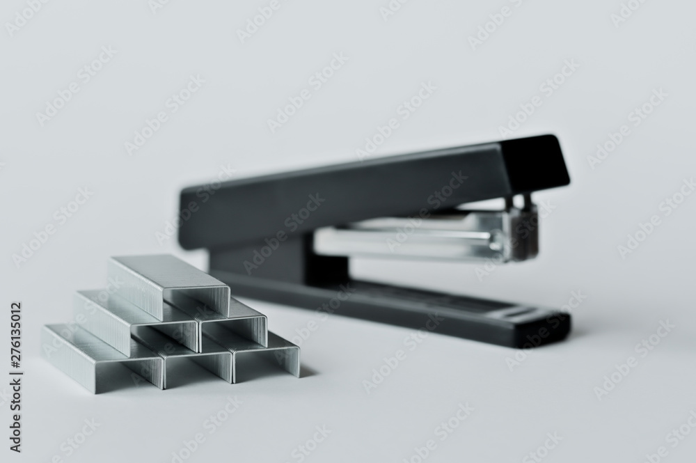 Stapler black with paper clips isolated on white background. Stapler black with paper clips isolated on white background.