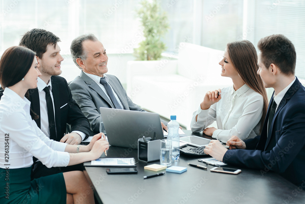 business colleagues talking at Desk in the office business colleagues talking at Desk in the office