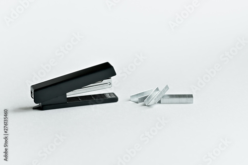 Stapler black with paper clips isolated on white background.