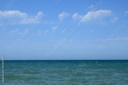 Fototapeta Naklejka Na Ścianę i Meble -  Seashore in summer, with clouds in the sky, with waves