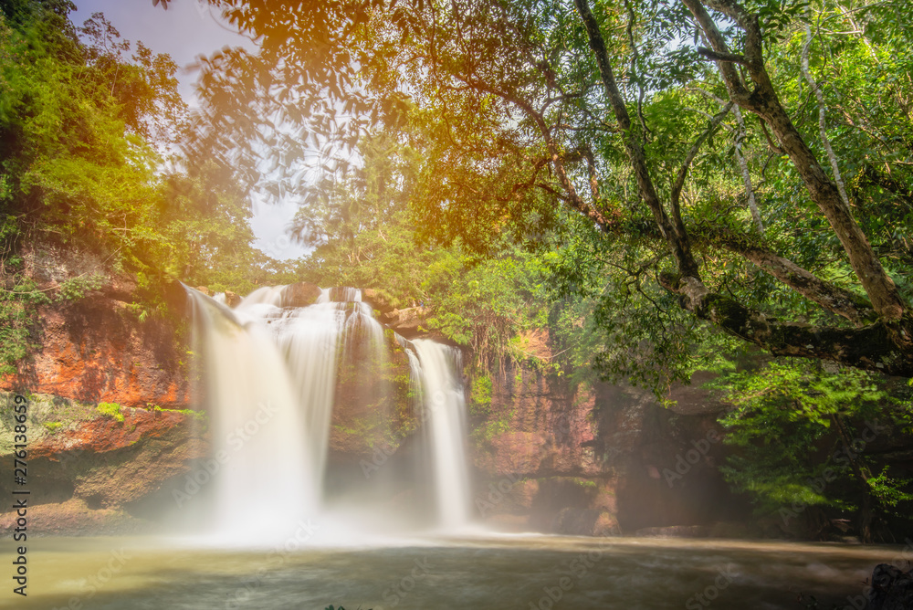 Obraz premium Here is the paradise on the world.The waterfall and beautiful perfect rainbow.Natural will always comfort you and make you feel comfortable.Large trees help this pic feel naturally, rainy season