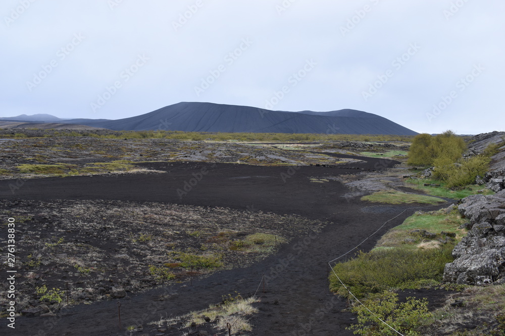 Landscape with many lava craters at grotto Grotagja Cave in Myvatn, Iceland 