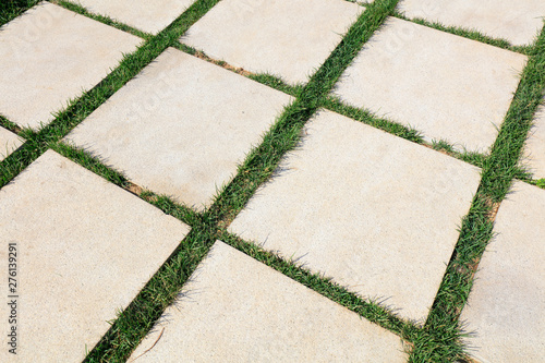 Cement floor tiles and grass