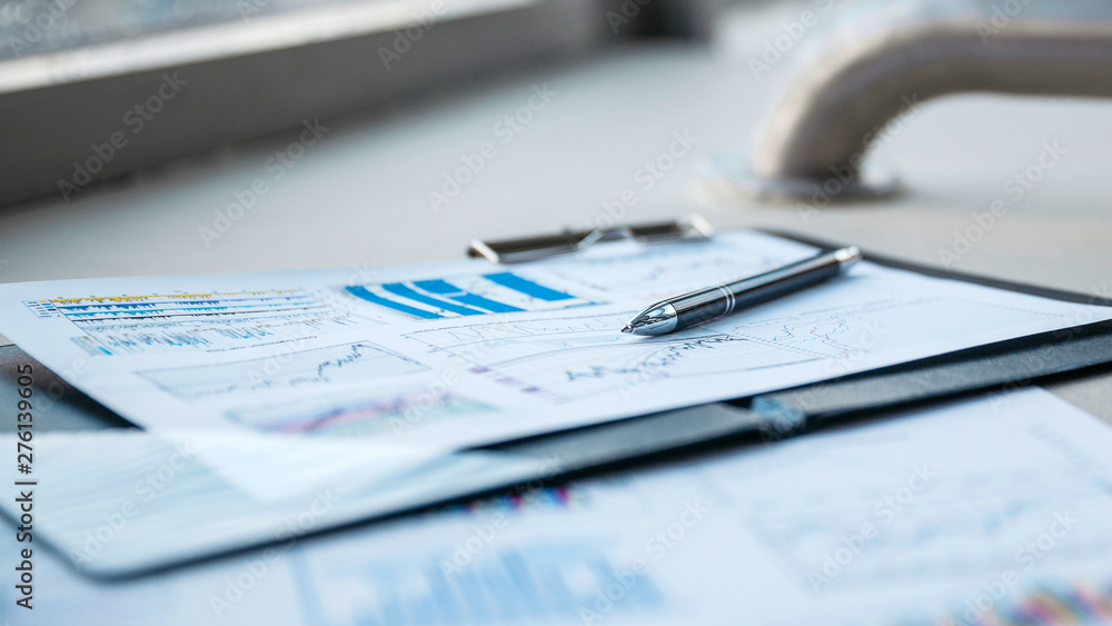 pen and financial documents on the desktop in the office