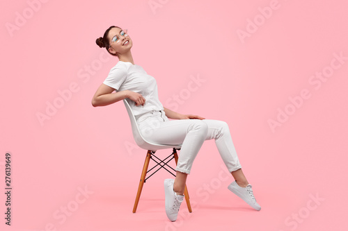 Relaxed teen girl sitting on chair