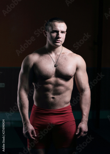 portrait of handsome male bodybuilder isolated on black background