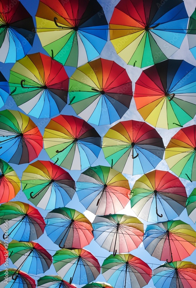 A huge number of umbrellas rainbow-colored fly into the sky