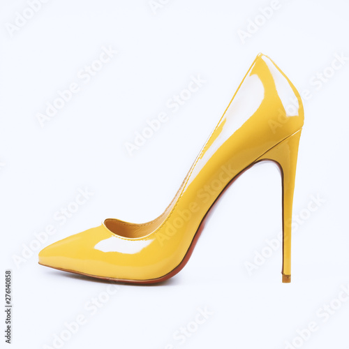 female yellow shoes on white background
