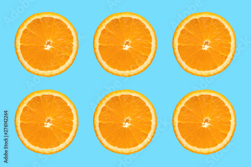 Juicy orange slice on blue background. Sliced ​​Citrus Fruits