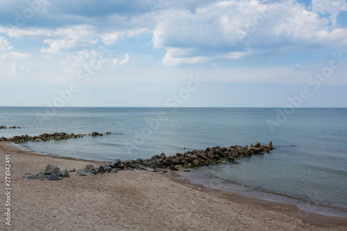 Landscape with beach and breakwaters at sunny day in Niechorze, Zachodniopomorskie, Poland