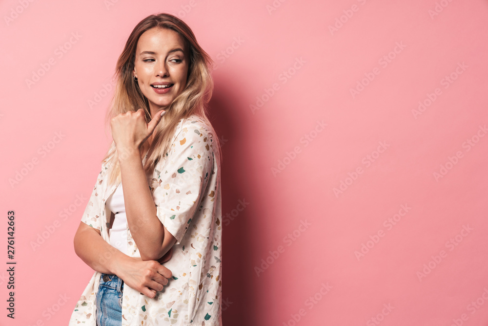 Beautiful smiling blonde woman posing isolated over pink wall background. Beautiful smiling blonde woman posing isolated over pink wall background.