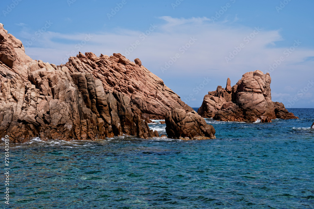 Rugged rock formation at a turquoise beach at La Sorgente, Costa Paradiso in Sardinia (Italy) with turquoise blue sea