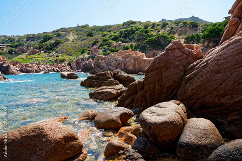 Rugged rock formation at a turquoise blue beach at La Sorgente, Costa Paradiso in Sardinia (Italy) with turquoise blue sea