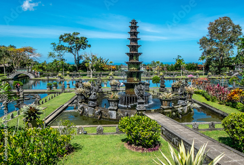 Tirta Gangga, Water Palace with fountain and natural pond. Travel and architecture background. Indonesia, Bali island. photo