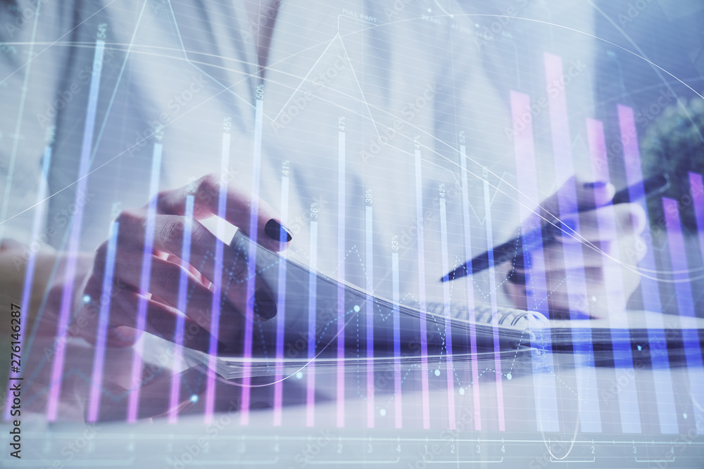 Financial chart drawn over hands taking notes background. Concept of research. Multi exposure Financial chart drawn over hands taking notes background. Concept of research. Multi exposure