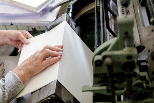 Photos Machine for stitching book pages with threads in typography.