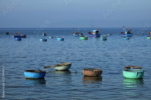 pier and basket boats in asian fishing village © Thang