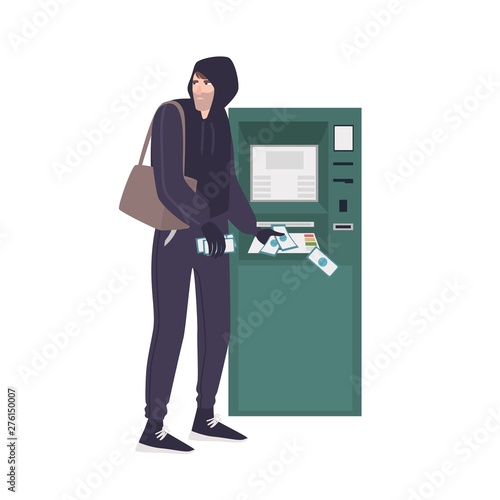 Male thief stealing money banknotes from ATM