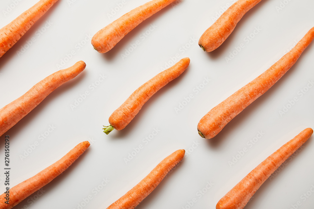 flat lay with fresh carrots on white background - obrazy, fototapety, plakaty 