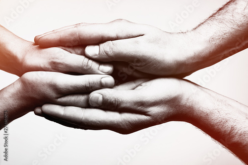 Concept of caring, tenderness, protection. Male and female hands touch each other.
