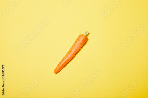 top view of organic carrot on yellow background