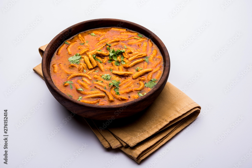 Dhaba style Sev bhaji/sabzi/curry made in tomato curry with gathiya shev, served in a bowl or karahi, selective focus Dhaba style Sev bhaji/sabzi/curry made in tomato curry with gathiya shev, served in a bowl or karahi, selective focus
