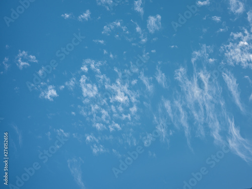Blue sky with white clouds close up in the summertime